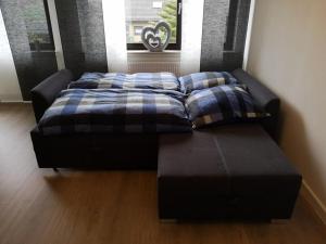 a bed and a couch in a room at Ferienwohnung am Kreuzfelsen in Bestwig