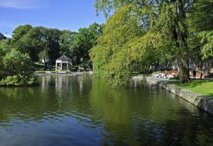 a view of a river with a gazebo in a park at Central Apartment Stavanger 2 Bedroom Sleeps 4 in Stavanger