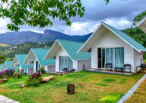 a row of houses with mountains in the background at Gardenia Kanthalloor in Kanthalloor