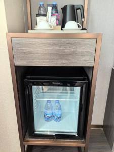 two bottles of water sitting inside of a refrigerator at Langliz Hotel Capital Airport New International Exhibition Center Branch in Beijing