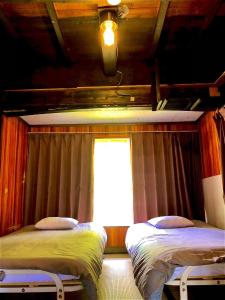 two beds in a room with a window at Minamikoma-gun - House - Vacation STAY 19040 in Kajikazawa