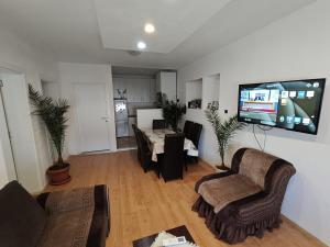 a living room with a flat screen tv on the wall at Busi Apartman in Strumica