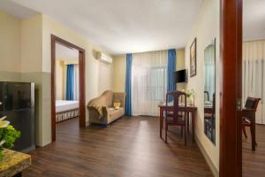 a living room with a couch and a table at Sea Front Apartment & Spa Da Nang in Danang
