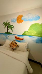 a bedroom with a painting on the wall with a bed at WAKE UP @Lanta Hotel : Cafe in Ko Lanta