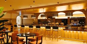 a restaurant with tables and chairs and a bar at Union Hotel in Toronto