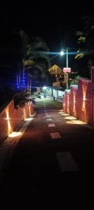 an empty street at night with a cross in the background at South point in Ammatti
