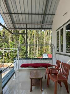 a bedroom with a bed and two chairs and a table at South point in Ammatti