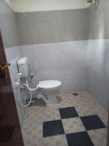 a bathroom with a toilet and a tile floor at South point in Ammatti