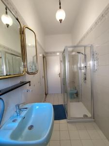 a bathroom with a blue sink and a shower at Villa Mehari in Pisa
