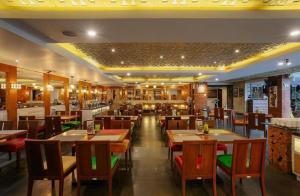 a restaurant with wooden tables and chairs in it at Hotel Radhe in New Delhi +22 photos