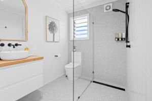 ein Badezimmer mit Dusche, Toilette und Waschbecken in der Unterkunft Salt & Sky - Luxe Coastal Getaway in Coffs Harbour
