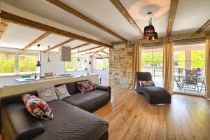 a living room with a couch and a table at Villa Nikolina in Šišan