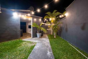 a patio with plants and lights on a wall at villa piscine jacuzzi in Petite Île