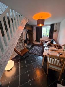 a living room with a staircase and a table at Welsh hilltop escape in Hoel-galed