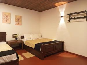 Postel nebo postele na pokoji v ubytování Aura Hilltop Holiday Homestay