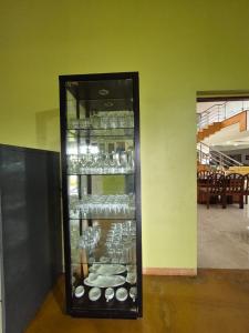 a display case filled with dishes in a room at Charu's Villa By Elite Stays in Jāmb +3 photos