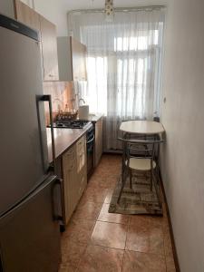 a small kitchen with a table and a counter top at Old Center Apartment in Craiova
