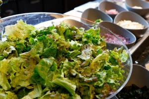 a salad in a bowl on a table with other dishes at KOKO HOTEL Kobe Sannomiya in Kobe +27 photos