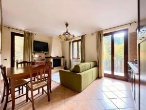 a living room with a table and a dining room at La Dimora San Rocco, Montagna e Relax in Roccaraso