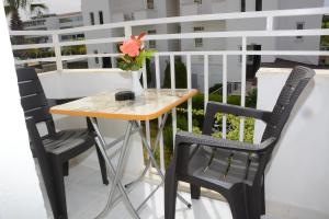 a table and chairs on a balcony with a vase of flowers at Hotel Dream Of Side in Side