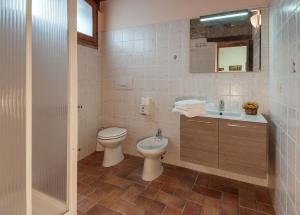 a bathroom with a toilet and a sink at Casa Tiglio in Pratovecchio +32 photos