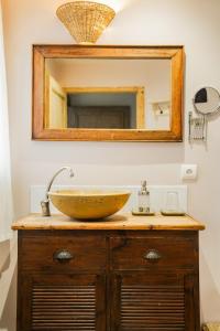 a bathroom with a sink and a mirror at Domaine de Venoise, Château 31 personnes in Noyers-sur-Serein