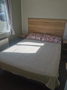 a bedroom with a bed with a white comforter at Thornesbay holiday park in Isle of Wight