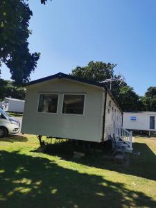 a tiny house is sitting in a yard at Thornesbay holiday park in Isle of Wight
