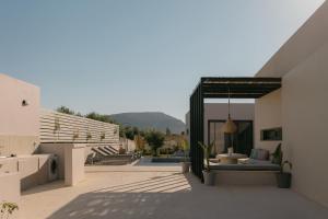 a backyard of a house with a patio at Unlimited Terra Villas, Charming Nature Escapes, By ThinkVilla in Hersonissos
