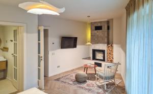 a living room with a chair and a fireplace at Stone Nest in Călimăneşti