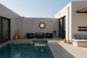 a living room with a swimming pool in a house at Unlimited Terra Villas, Charming Nature Escapes, By ThinkVilla in Hersonissos