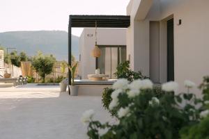 a house with a patio with a view of a mountain at Unlimited Terra Villas, Charming Nature Escapes, By ThinkVilla in Hersonissos +78 photos