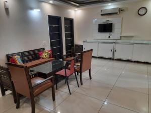 a kitchen and dining room with a table and chairs at Shukla Bhawan in Panchkula