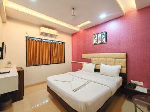 Ένα ή περισσότερα κρεβάτια σε δωμάτιο στο Great Samrat Residency