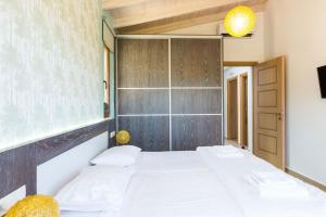 a bedroom with a white bed and a mirror at Kampos Villa 1 in Achlades
