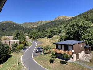 a house on the side of a road at T2 avec vue sur les montagnes et wifi in Le Lioran