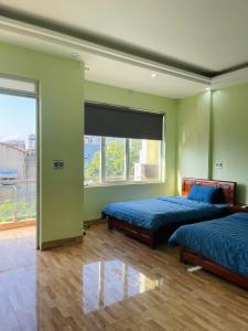 Postel nebo postele na pokoji v ubytování Nhà Nghỉ Hải Dũng