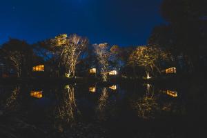 Nachtansicht eines Sees mit eingeschalteter Beleuchtung in der Unterkunft Earthboat Nasu in Nasu