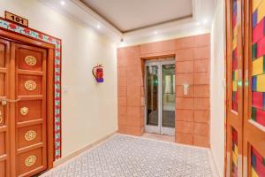 a hallway with a door and a tile floor at Palette Heritage Varanasi Retreat in Varanasi