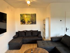 a living room with a couch and a table at Berghütte Astenpanorama in Winterberg