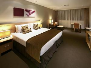 a hotel room with a large bed and a desk at The Sebel Bowral Heritage Park in Bowral