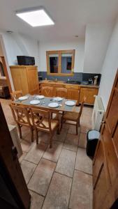 a kitchen with a table and chairs in a room at Eeckhoutveld Hébergement 3 chambres in Merckeghem