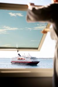 a cruise ship on the water in the ocean at Quality Hotel Ålesund in Ålesund