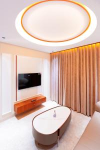 a living room with a large round table and a tv at celestia by thoppil in Kottakkal +29 photos