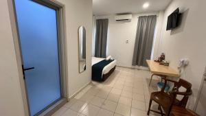 a hotel room with a bed and a table and a window at Cojoy Hotel @ Chinatown in Kuala Lumpur