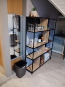 a room with a book shelf in a room at Féerie de la Vigne in Ammerschwihr +1 photo