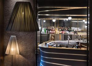 a bar in a restaurant with a lamp and a counter at Hotel Valentinerhof in Siusi