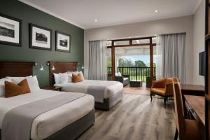 a hotel room with two beds and a balcony at Protea Hotel by Marriott George King George in George +55 photos