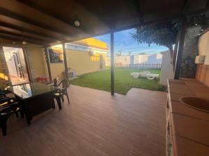 a view of a patio with a table and chairs at Chalet Playa Paraiso in Cádiz