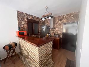 a kitchen with a bar in a room at Chalet Playa Paraiso in Cádiz